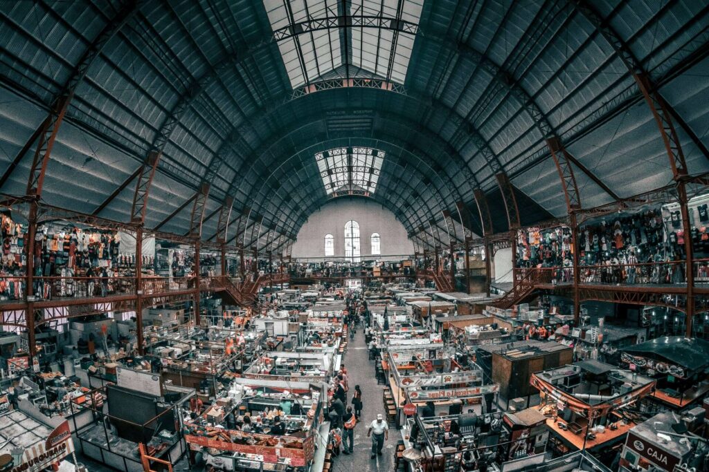 An indoor market with different types of vendors