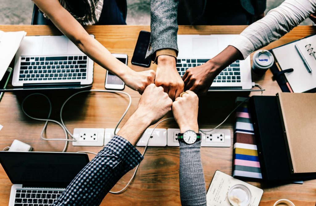 Five People Fistbumping