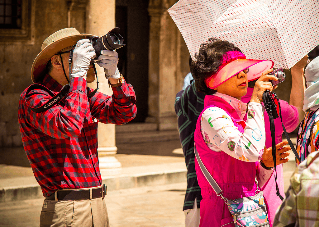 Chinese tourists photographing a tourist site